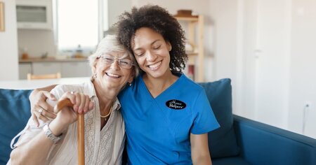 Home Helpers caregiver hugging a happy patient